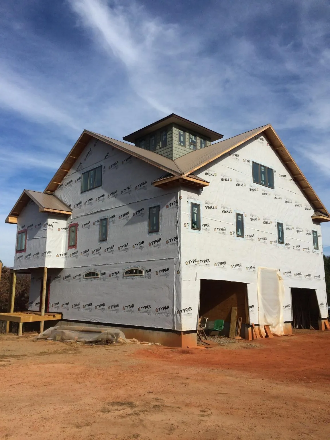 New two story house under construction with a cupola and gabled roofs in Washington